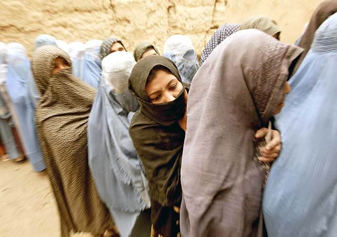 Afghani women line up to vote during the first democratic presidential election in Kabul, Afghanistan, Oct.9, 2004.
