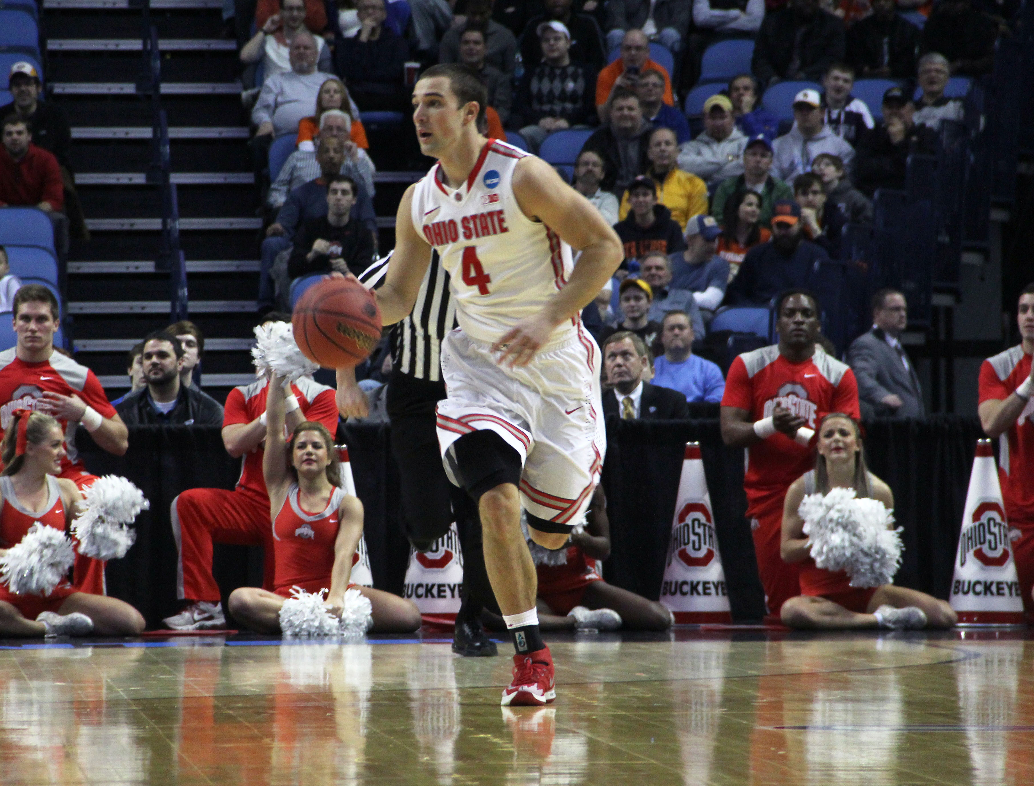 Senior guard Aaron Craft (4) caries the ball down the court in a game against Dayton. OSU lost, 60-59, at First Niagara Center March 20.