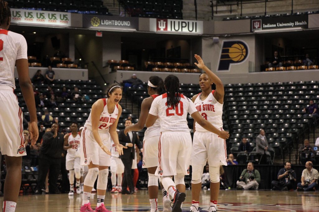OSU junior guard Asia Doss is congratulated by teammates while returning to the bench during the Buckeyes 99-68 victory over Northwestern on March 3. Credit: Ashley Nelson | Sports Director