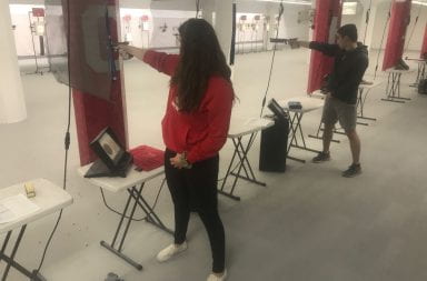 Abeln and Gens aim their pistols at the target