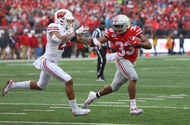 Ohio State running back Master Teague stiff-arms a Wisconsin defender