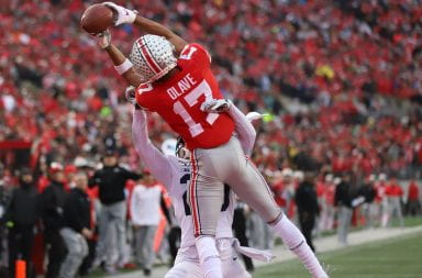 Ohio State wide receiver Chris Olave catches a pass over a Penn State defender
