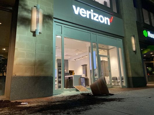 An overturned potted plant lays outside the shattered Verizon storefront. Credit: Max Garrison | Asst. Campus Editor