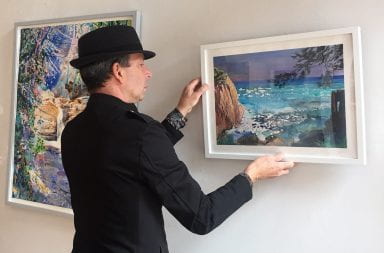 Michael Kaiser hangs "View," his exhibition opening at the Sherrie Gallery during the Virtual Gallery Hop May 2. Credit: Courtesy of Sherrie Hawk