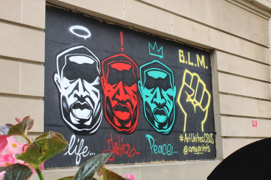 Murals have been painted on the plywood covering windows and doors of businesses in Columbus, Ohio. Credit: André White | Arts & Life Producer