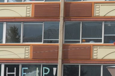 Students in COVID-19 quarantine and isolation housing in Lawrence Tower decorate their windows.