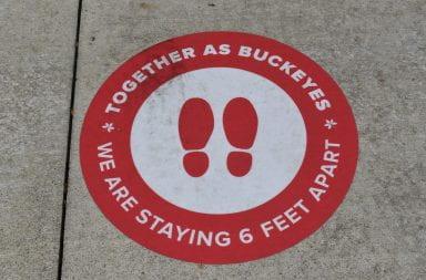 the together as buckeyes social distancing signs on the sidwalks around campus