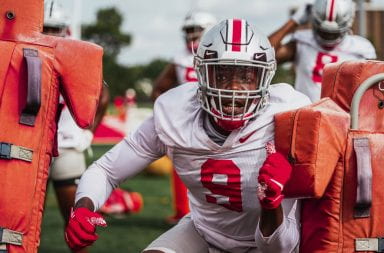 Sophomore defensive end Zach Harrison going through a drill with blocking dummies at an Ohio State football practice