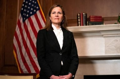 Amy coney barrett stands for a portrait
