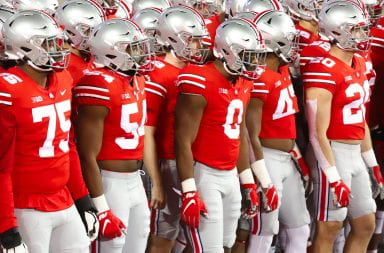 the ohio state football team stands in line waiting to take the field
