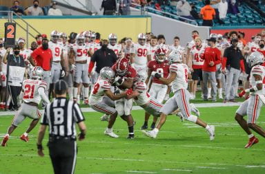 The Ohio State defensive line tries to take down an Alabama player moving with the ball during the Ohio State vs. Alabama National Championship Game. Alabama won 52-24. Credit: Mackenzie Shanklin | Photo Editor