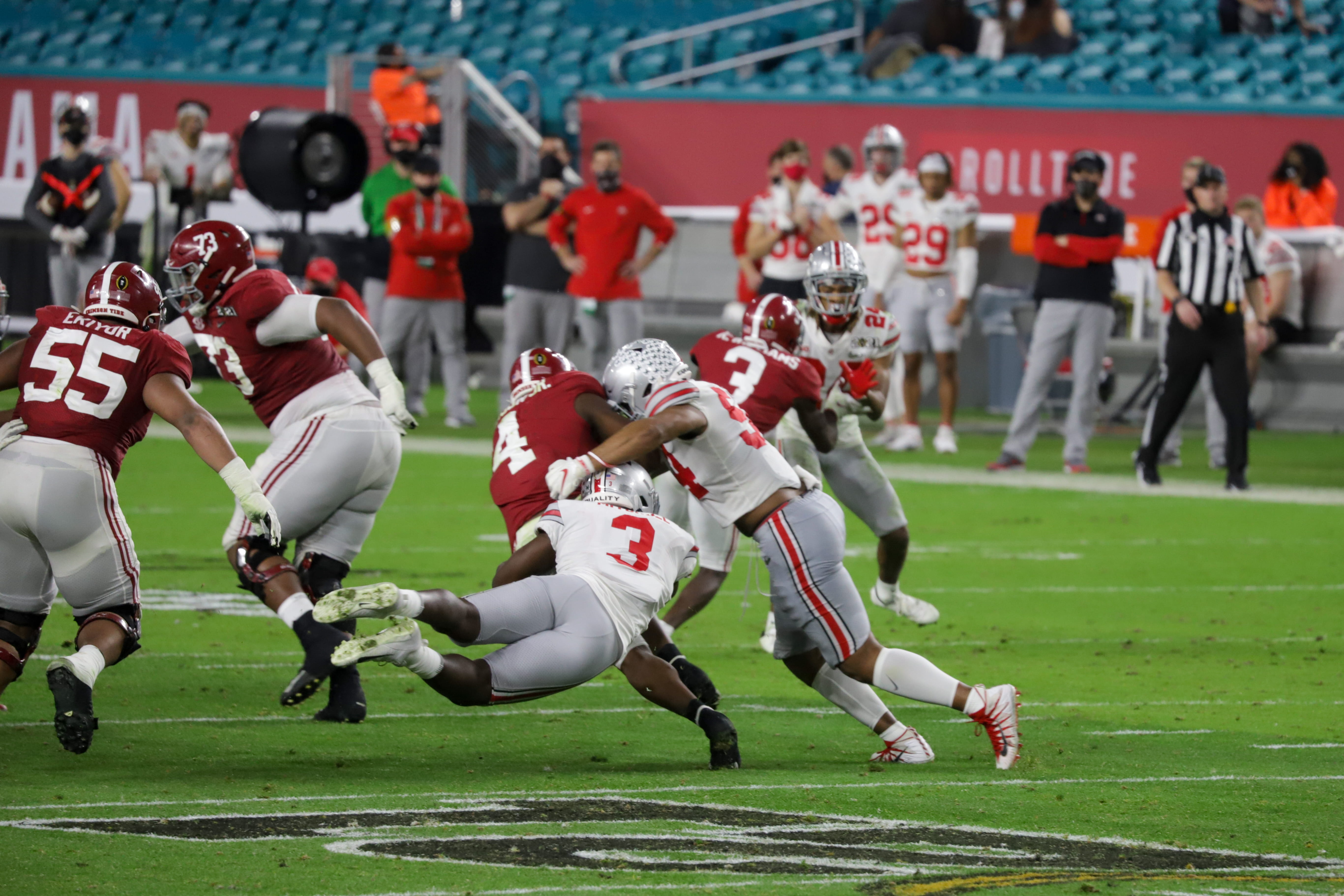Ohio State then-junior linebacker Teradja Mitchell (3) and then-junior defensive end Tyler Friday (54) tackle an Alabama player during the Ohio State vs. Alabama National Championship game on Jan. 11. Alabama won 52-24. Credit: Mackenzie Shanklin | Photo Editor