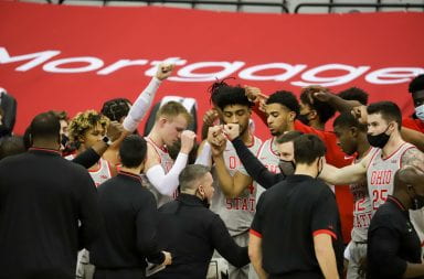 The Ohio State Buckeyes raise their fists before going back to the court