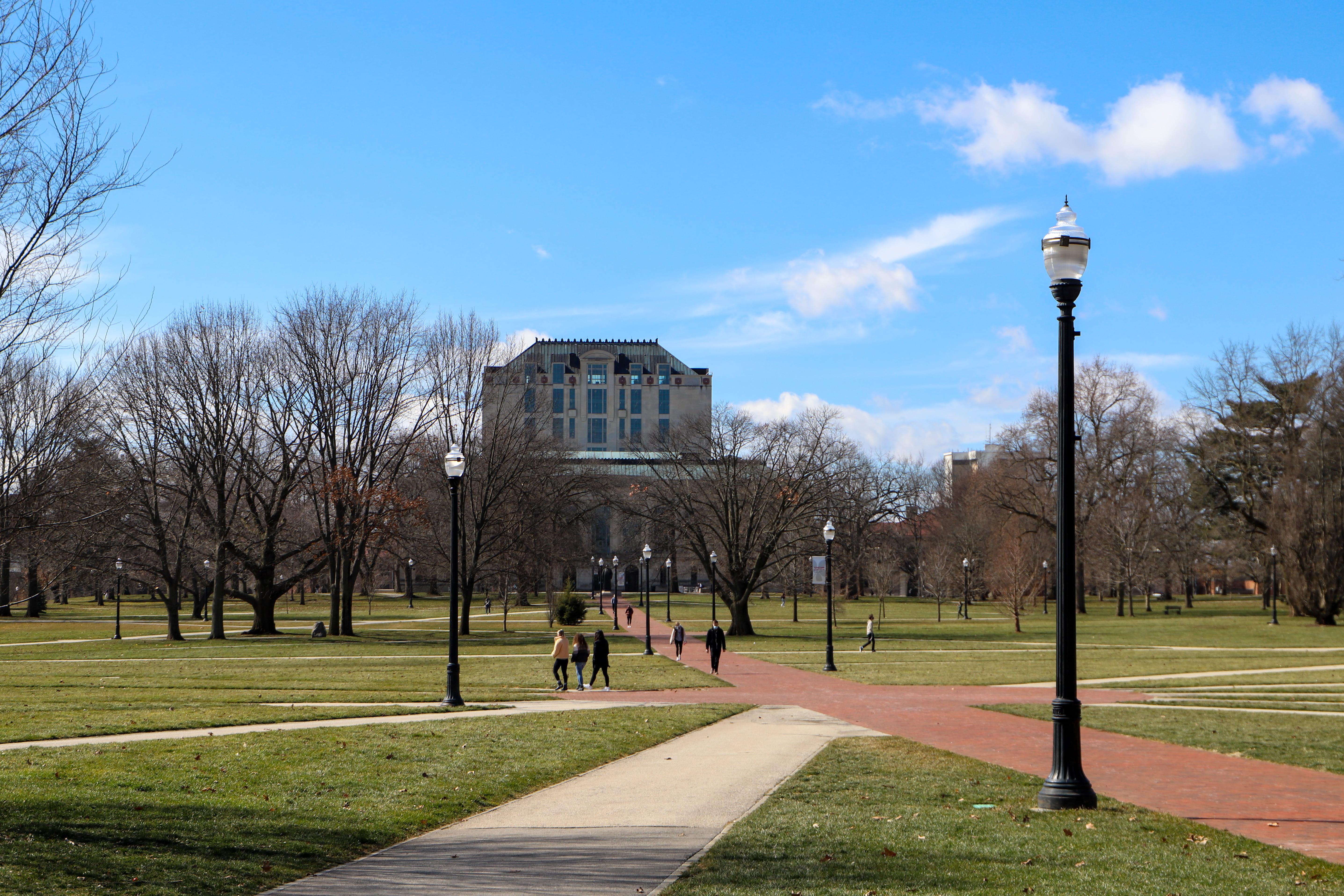 the Oval with people walking on paths and thompson library in the background