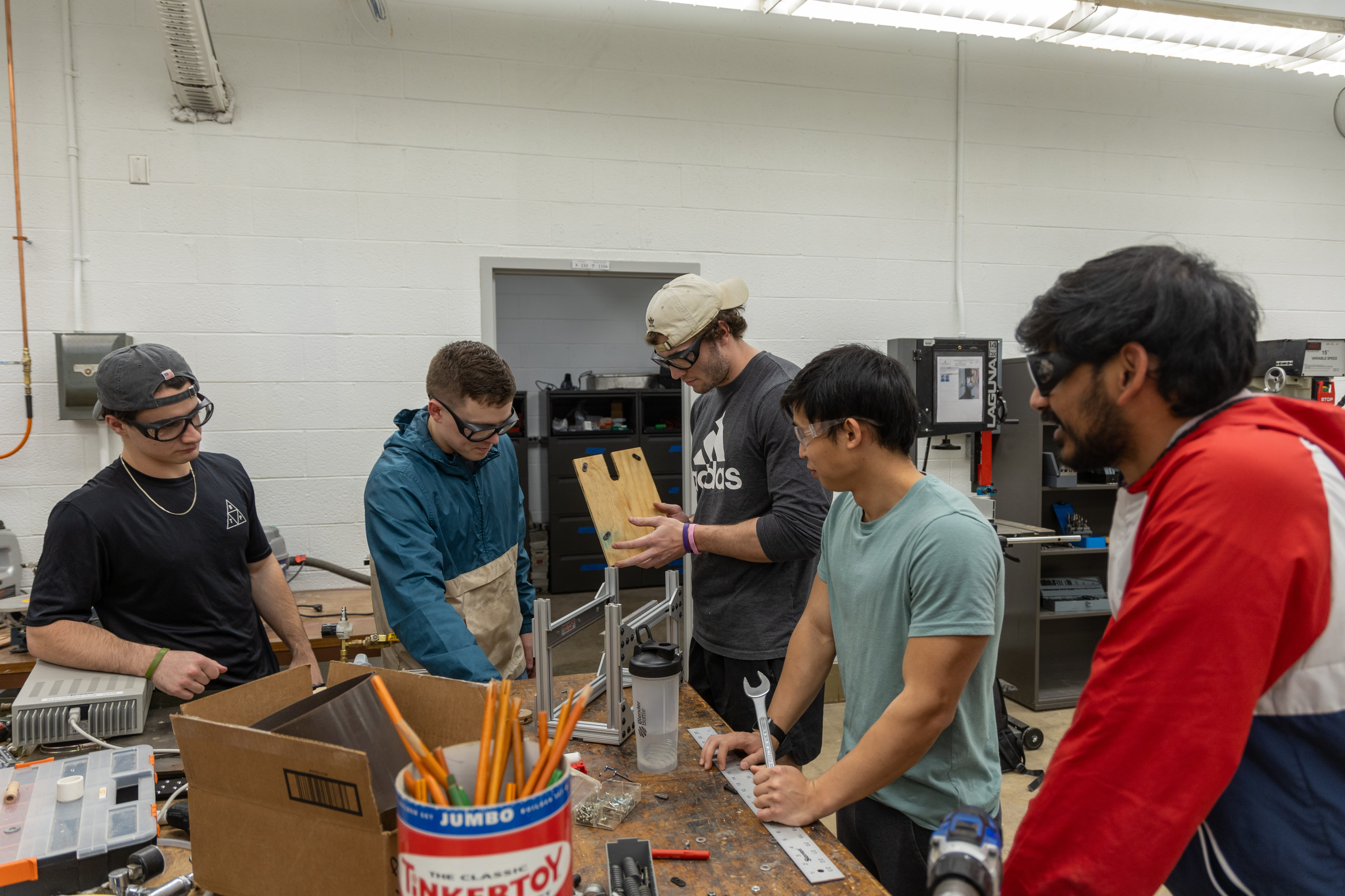 Fourth-years Matt Milanese, Owen Brown, Noah Balis, Alex Chou and Nora Patel working on a project in one of the Makerspace classrooms at Bolz Hall. Credit: Caleb Blake | Photo Editor