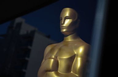 An Oscar statue is seen in the window of the Academy Museum of Motion Pictures on March 18, 2022, in Los Angeles. Credit: Robyn Beck | Getty Images (via TNS)