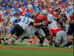 Shelby Lum / Photo editor Redshirt senior running back Jordan Hall pushes through the line with the ball in a game against Buffalo on Aug. 31. OSU won, 40-20
