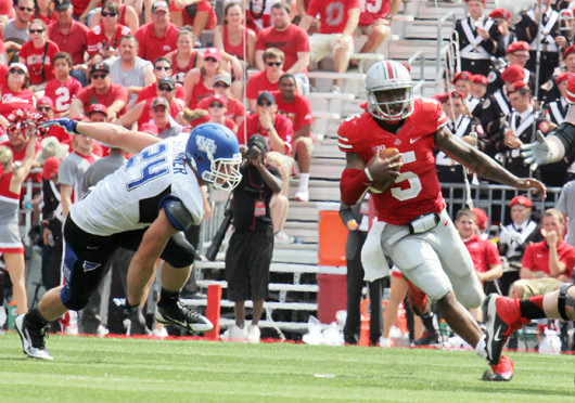 Junior quarterback Braxton Miller (5) runs down the field for extra yards in a game against Buffalo Aug. 31 at Ohio Stadium. OSU won, 40-20. Credit: Shelby Lum / Photo editor