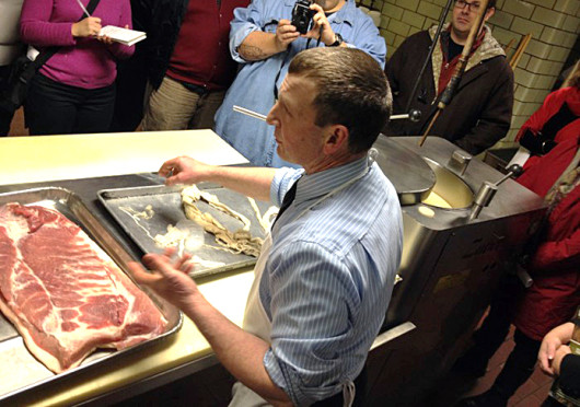 Albert Thurn, owner of Thurn’s, which is located at 530 Greenlawn Ave., teaching tour-goers about the smoking and curing meat process. Credit: Courtesy of Columbus Food Adventures / Thurn’s  