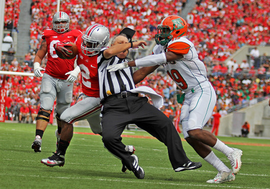 Redshirt-senior running back Jordan Hall (2) uses the referee as a blocker during a game against Florida A&M Sept. 21 at Ohio Stadium. OSU won, 76-0. Credit: Shelby Lum / Photo editor