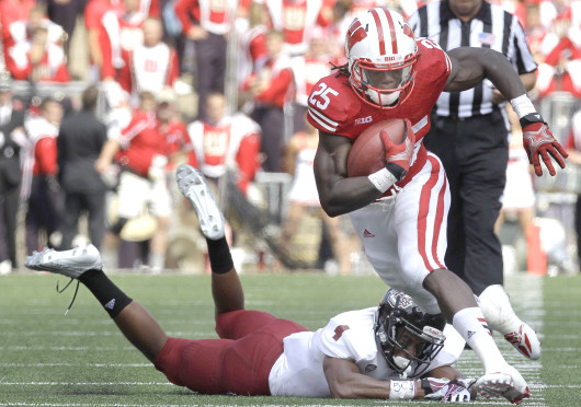 Wisconsin running back Melvin Gordon (25) avoids the tackle of Massachusetts defensive back Randall Jette in the second quarter on Saturday, August 31, 2013, at Camp Randall Stadium in Madison, Wisconsin. The Badgers defeated UMass, 45-0. Credit: Courtesy of MCT