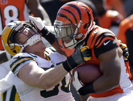 Green Bay Packers inside linebacker A.J. Hawk (50) is stiff-armed by Cincinnati Bengals running back Giovani Bernard (25) during the second quarter on Sept. 22 at Paul Brown Stadium. Credit: Courtesy of MCT