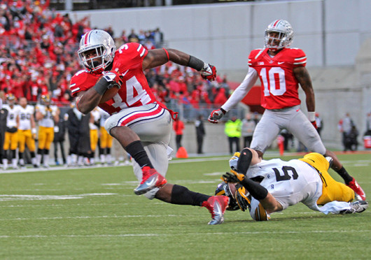 Senior running back Carlos Hyde breaks a tackle on his way to a touchdown during a game against Iowa Oct. 19 at Ohio Stadium. OSU won, 34-24. Credit: Shelby Lum / Photo editor