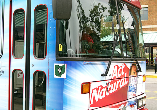 The Natty Caddy, a University Village bus, has panel advertisements for Natural Light beer covering the exterior of the bus. Credit: Chelsea Savage / Lantern photographer