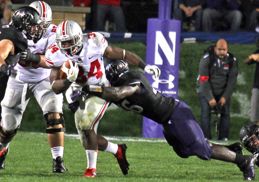 Senior running back Carlos Hyde (34) breaks a tackle during a game against Northwestern Oct. 5 at Ryan Field. OSU won, 40-30. Credit: Shelby Lum / Photo editor