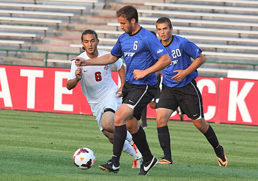 Junior midfielder Yianni Sarris (6) attempts to tackle the opposing player during a match against IPFW Aug. 20 at Jesse Owens Memorial Stadium. OSU won, 2-0. Credit: Shelby Lum / Photo editor