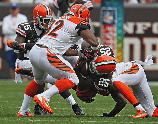 Cleveland Browns running back Chris Ogbonnaya (25) is upended by Cincinnati Bengals safety George Iloka, right, during a game at FirstEnergy Stadium. The Browns won, 17-6. Credit: Courtesy of MCT