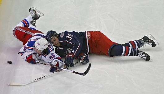 Michael Chaput (39) of the Columbus Blue Jackets and Mats Zuccarello (36) of the New York Rangers battle for a puck during a game at Nationwide Arena Nov. 7. The Rangers won, 4-2. Credit: Courtesy of MCT