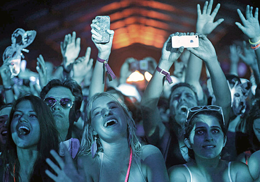 Audience members sing, watch and hold up their phones during DJ Kaskade’s set at the Coachella festival in Indio, Calif. April 21, 2012. Credit: Courtesy of MCT