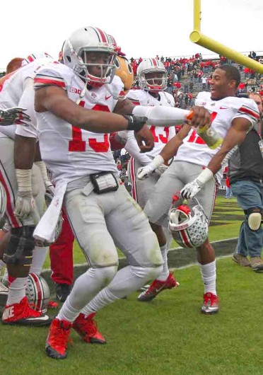 Redshirt-senior quarterback Kenny Guiton (13) dances with his teammates after a game against Purdue Nov. 2 at Ross-Ade Stadium. OSU won, 56-0. Credit: Shelby Lum / Photo editor