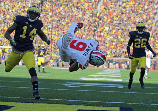 Junior wide receiver Devin Smith (9) dives into the end zone during The Game Nov. 30 at Michigan Stadium. OSU won, 42-41. Credit: Shelby Lum / Photo editor