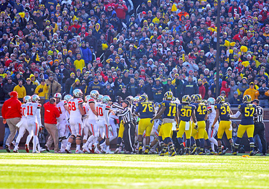 OSU and Michigan players fight on the field during a game Nov. 30 at Michigan Stadium. OSU won, 42-41. Credit: Shelby Lum / Photo editor