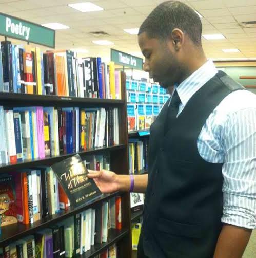 Ohio State graduate Alex Warren holds 'Wisdom & Vision: 70 Inspiring Poems on How to Live a Meaningful Life,' the book he authored, at a Barnes & Noble store. Credit: Courtesy of Alex Warren