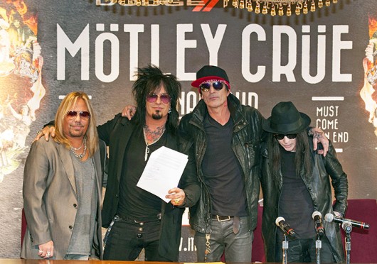 Motley Crue band members Vince Neil, Nikki Sixx, Tommy Lee and Mick Mars stand together with their signed 'Cessation of Touring' document Jan. 28.  Credit: Courtesy of MCT