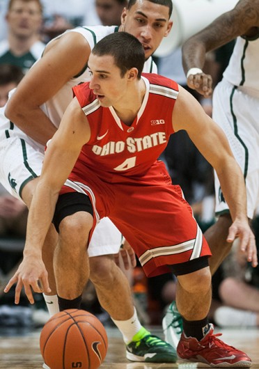 OSU senior guard Aaron Craft (4) drives to the basket during a game against Michigan State Jan. 7 at the Breslin Center. OSU lost, 72-68. Photo courtesy of Danyelle Morrow / The State News