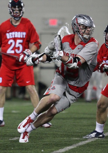 Then-sophomore midfielder Jesse King (19) advances the ball during a game against Detroit Feb. 9 at the Woody Hayes Athletic Center. OSU won, 14-8. Credit: Shelby Lum / Photo editor
