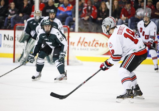 Junior forward Ryan Dzingel (18) prepares to shoot the puck during a game against Michigan State Jan. 11 at the Schottenstein Center. The teams tied, 1-1. Credit: Kelly Roderick / For The Lantern