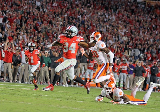 Senior running back Carlos Hyde (34) avoids a tackler during the 2014 Discover Orange Bowl against Clemson Jan. 3 at Sun Life Stadium. OSU lost, 40-35. Credit: Shelby Lum / Photo editor
