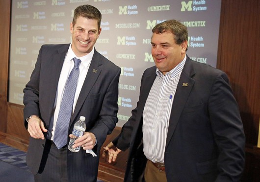 Michigan coach Brady Hoke (right) and offensive coordinator, Doug Nussmeier shake hands after a news conference in Ann Arbor, Mich., Jan. 10. Credit: Courtesy of MCT