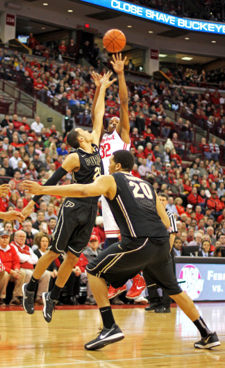 Senior guard Lenzelle Smith Jr. (32) shoots over a defender during a game against Purdue Feb. 8 at the Schottenstein Center. OSU won, 67-49. Credit: Shelby Lum / Photo editor