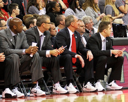 OSU coaches (from left) Dave Dickerson, Jeff Boals, Thad Matta and Greg Paulus look on during a game against Penn State Jan. 29 at the Schottenstein Center. OSU lost, 71-70, in overtime. The coaches wore tennis shoes to show support for Coaches v. Cancer. Credit: Shelby Lum / Photo editor
