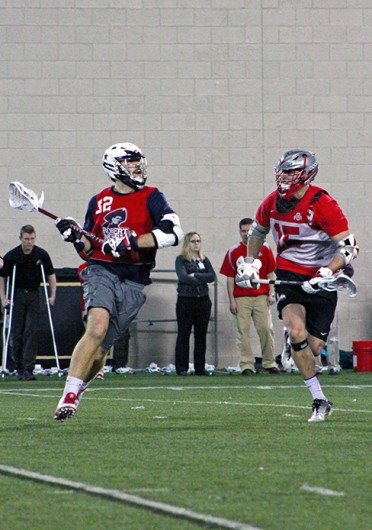 Senior midfielder Nick Diegel (15) attempts to stop an opposing player during a game against Robert Morris Feb. 1 at the Woody Hayes Athletic Center. OSU won, 11-7. Credit: Ryan Robey / For The Lantern