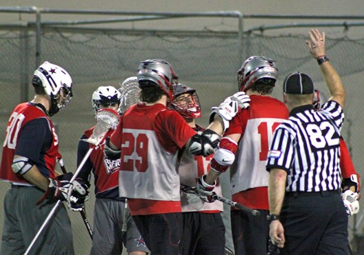 Members of the OSU men's lacrosse team celebrate a goal during a game against Robert Morris Feb. 1 at the Woody Hayes Athletic Center. OSU won, 11-7. Credit: Ryan Robey / For The Lantern