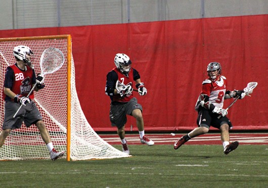Freshman attackman JT Blublaugh (9) looks for an open teammate during a game against Robert Morris Feb. 1 at the Woody Hayes Athletic Center. OSU won, 11-7. Credit: Ryan Robey / For The Lantern