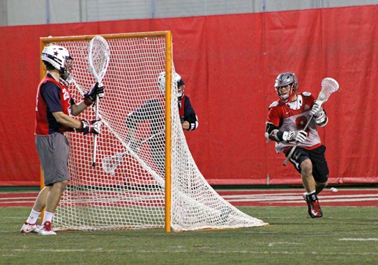  Junior attackman Reegan Comeault (8) looks for an open teammate during a game against Robert Morris Feb. 1 at the Woody Hayes Athletic Center. OSU won, 11-7. Credit: Ryan Robey / For The Lantern