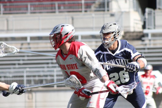 Junior midfielder Jesse King (19) looks to move the ball upfield during a game against Penn State at Ohio Stadium March 1. OSU lost, 11-7. Credit: Ryan Robey / For The Lantern